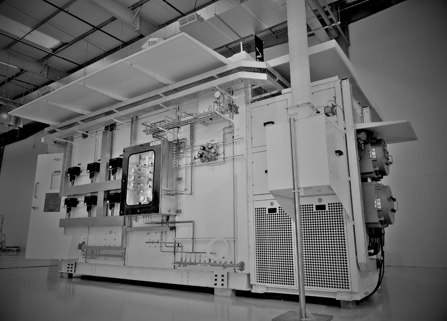 An AKAI analyzer shelter with a sample-handling panel, gas distribution lines and an HVAC unit, photographed in black and white